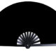 "Solid black hand clack fan with loud snap for festivals, parties, and performances."